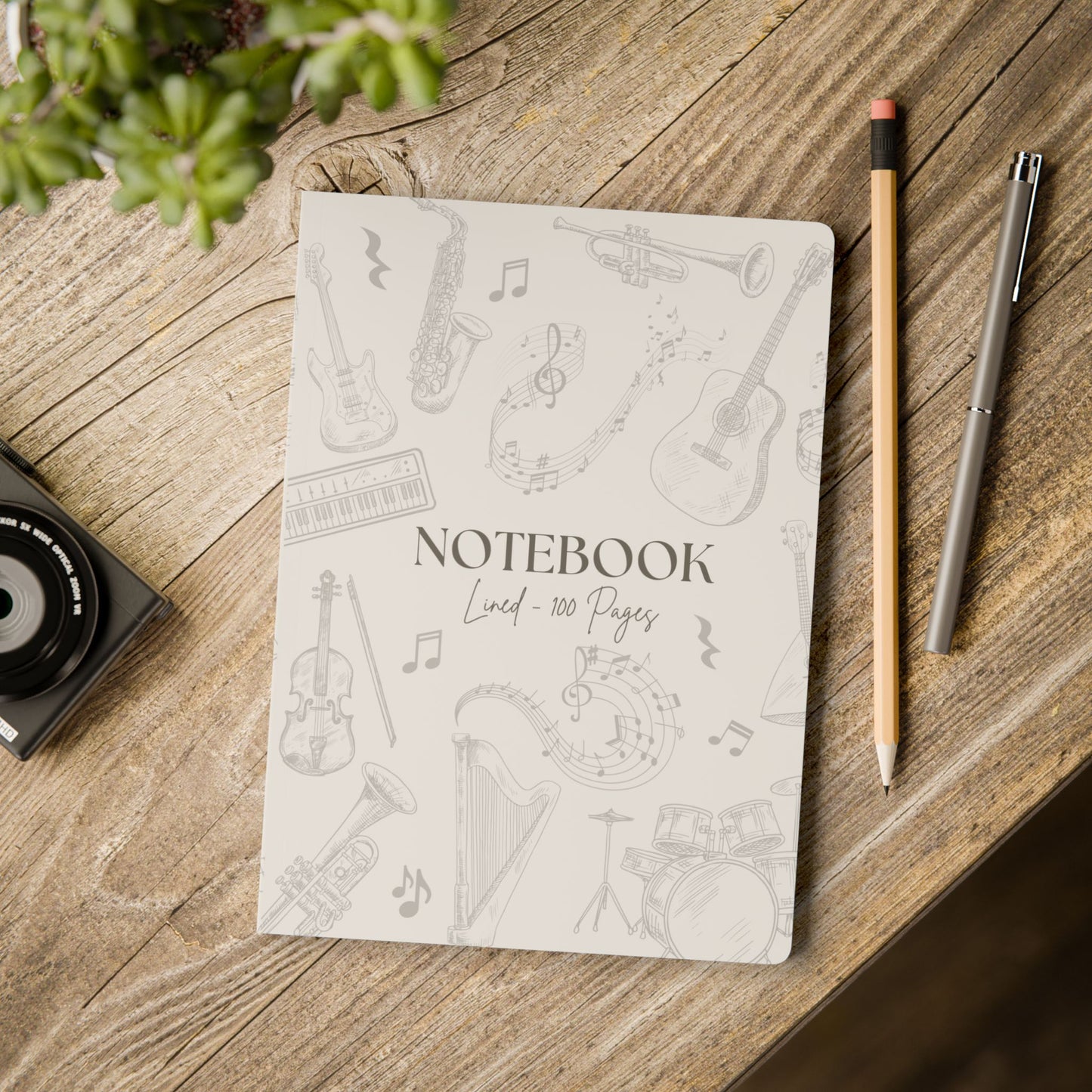 Notebook with musical instrument illustrations on a wooden surface with a pencil and pen.