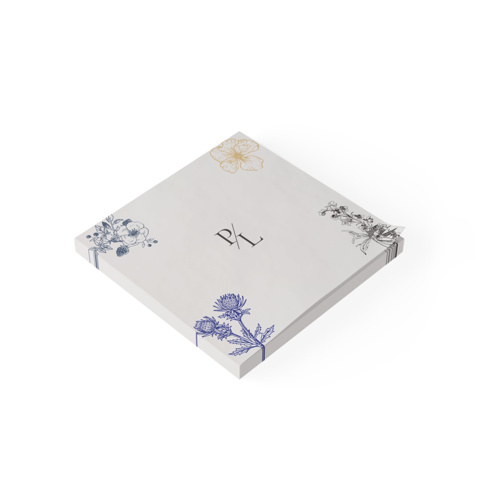 Notepad with floral designs and initials on a white background